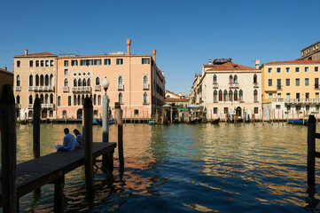 Couple Sitting on the pier in the city of Venice