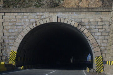 The entrance to a road tunnel that crosses the mountains. Road tunnel at the entrance.
