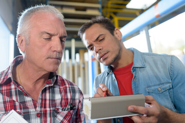 businessmen holding tablet in factory