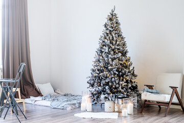 Christmas tree with presents and lights in light and airy living room