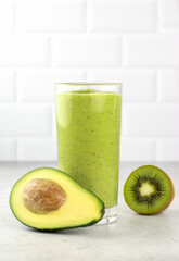 Avocado smoothie on a white background. Green smoothie with avocado, kiwi, banana on a white background. Selective focus. copy space.