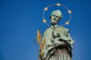Fototapeta na wymiar Statue of St. John of Nepomuk on Charles bridge, Prague. Czech Republic.
