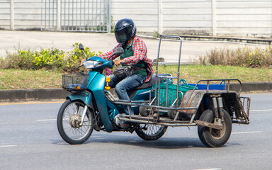 A person ride a motorcycle with a sidecar, Thailand