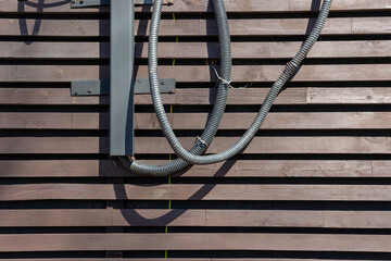 wires on the wall of a wooden building. old wooden building in the city or countryside. facade of an old house. daylight.