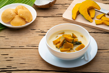 Coconut Milk Stewed Pumpkin,Thai dessert boiled sliced Pumpkin fruit in coconut milk with palm sugar in white bowl