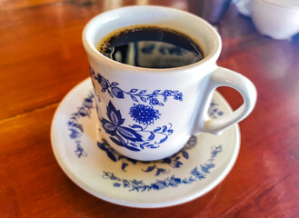 Blue white cup pot with black coffee wooden table Mexico.