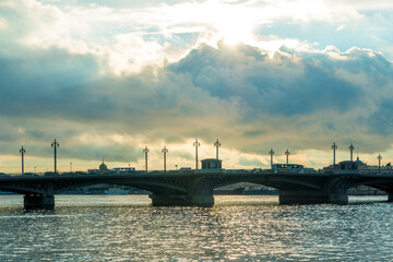 Fototapeta na wymiar Dramatic view of the palace bridge across the Neva River in the city of St. Petersburg. Russia