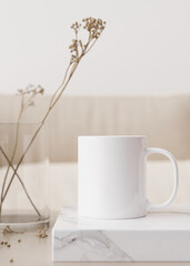 White mug mock up. Blank vertical template for your design, advertising, logo. Close-up view. Copy space. Cup standing on coffee table in modern interior. Minimalist coffee cup mockup. 3D rendering.