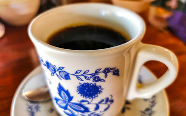 Blue white cup pot with black coffee wooden table Mexico.