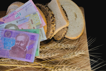 Ukrainian hryvnia and slices of bread and ears of wheat