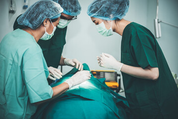 Asian doctor surgeon team, working in the operating room. to people health care and cosmetic...