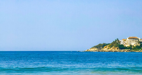 Fototapeta premium Beach sand blue water huge surfer waves Puerto Escondido Mexico.