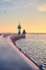 Lighthouse at Travemunde at the baltic sea in winter. High quality photo - obrazy, fototapety, plakaty