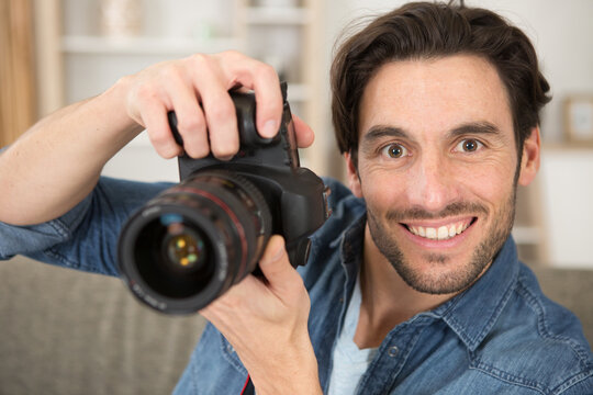 portrait of man holding a digital slr camera