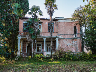 Facade of old vintage haunted castle or mansion on sunny summer day.