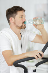 profile of sportsman quenching thirst from bottle