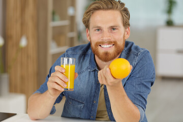 young handsome man having an orange juice