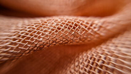 Linen thin fabric close up. Orange background
