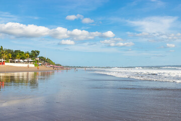 BALI, INDONESIA - OCTOBER 29, 2022: People walking on Petitenget beach with modern and expensive restaurants and hotels