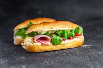sandwich french milk buns ham, cheese, lettuce green leaves bio product fresh healthy meal food snack on the table copy space food background rustic top view