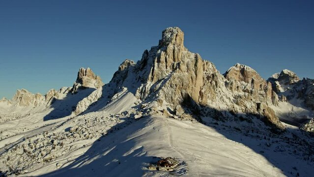 Drone footage of mountain peaks at sunrise in winter. Italian Alps.
