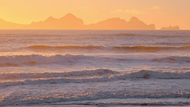 Sunrise over Stormy Sea, Shining Golden Waves with Sun Reflection at Sunset, Amazing light over Icelandic Nature, Shot in 8K Resolution 4320p