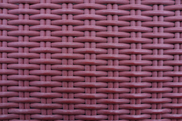 Knitted synthetic rattan material with traditional red cross texture for wallpaper and background.
