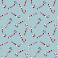 Seamless pattern with Christmas candies on bright blue background. Creative minimal X mas art. Copy space. Flat lay.