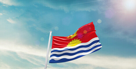waving flag of Kiribati in blue sky. the symbol of the state on wavy cotton fabric.