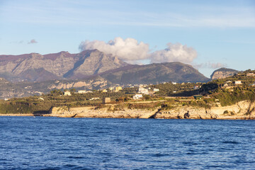 Fototapeta premium Rocky Coast and Homes near Touristic Town, Sorrento, Italy. Amalfi Coast. Sunny Evening