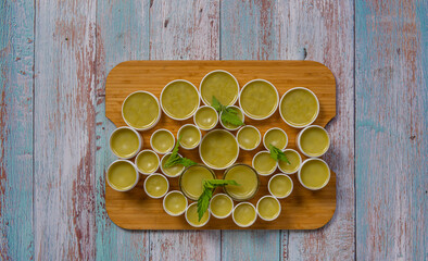 Wooden chopping board with marijuana healthy salve on blue old table