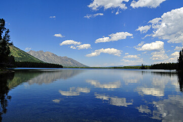 Fototapeta na wymiar Lake and clouds mirror image in Grand Teton National Park