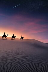 Fototapeta na wymiar Los reyes magos del Oriente, en sus camellos, en el desierto, guiados por la estrella polar.