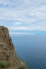 Beautiful summer landscape of Baikal Lake on sunny day. View of the rocky cape