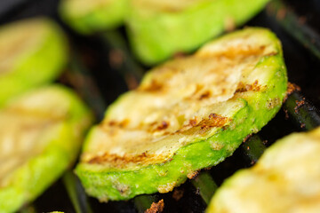 Grilled zucchini slice prepared on a grill. Close-up.