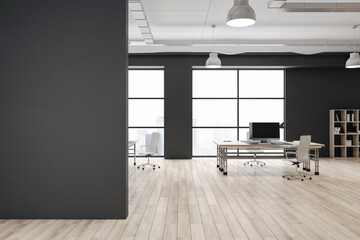 Fototapeta na wymiar Front view on blank dark wall in eco style spacious coworking office with city view from big windows, black walls and modern computers on wooden tables and wooden floor. 3D rendering, mockup