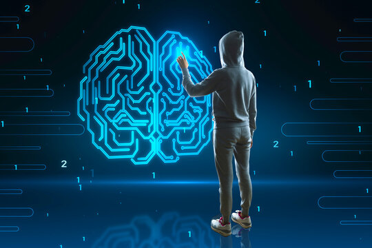 Back view of hacker in hoodie using abstract glowing human brain hologram on blurry background. Neurology research, hacking, data theft and artificial intelligence concept.