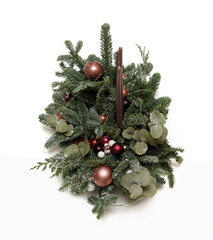 Christmas arrangement of freshly cut fir branches, decorated with Christmas balls and candles