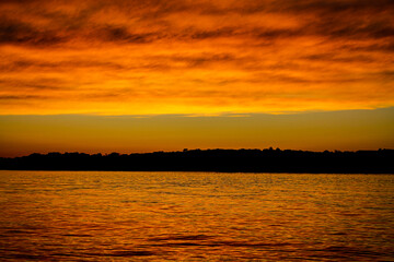 Naklejka premium sunset over the river