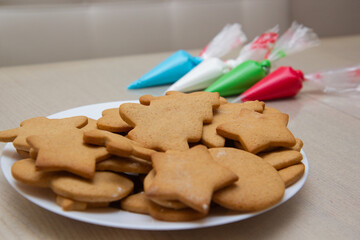 Christmas gingerbread in a plate and colored icing in bags