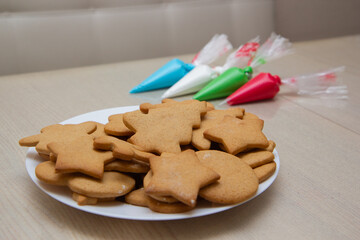 Christmas gingerbread in a plate and colored icing in bags