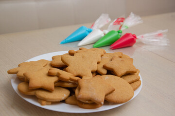 Christmas gingerbread in a plate and colored icing in bags