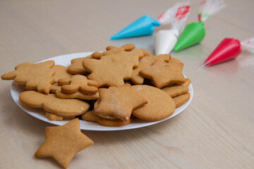 Christmas gingerbread in a plate and colored icing in bags