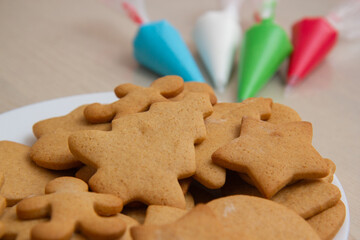 Christmas gingerbread in a plate and colored icing in bags