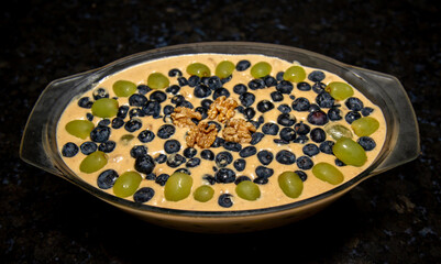Green grape stroganoff, walnuts and blueberries. Christmas special dessert. Closeup