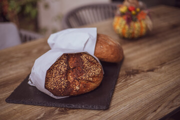 Fresh bread in a paper bag on a wooden table. The concept of natural products. gluten free bread.