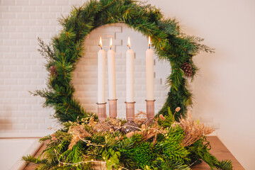 4 candles in a green wreath. Advent wreath with all 4 candles lit
