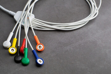 Colored wires and cables of Holter monitor device measuring heart rate and blood pressure with a...