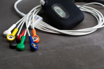 Holter, a medical device for a heart rate measurement with all the colorful cables on industrial...