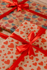 Obraz premium Romantic valentine day gift box for couple in love with heart ornament and red bow and silk ribbon.